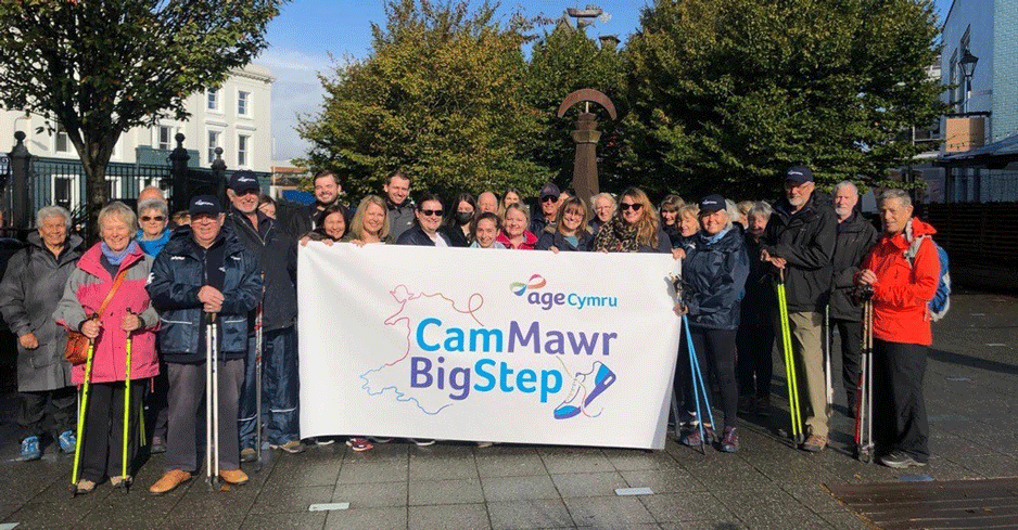The Big Step team gathered together holding the Age Cymru Big Step banner