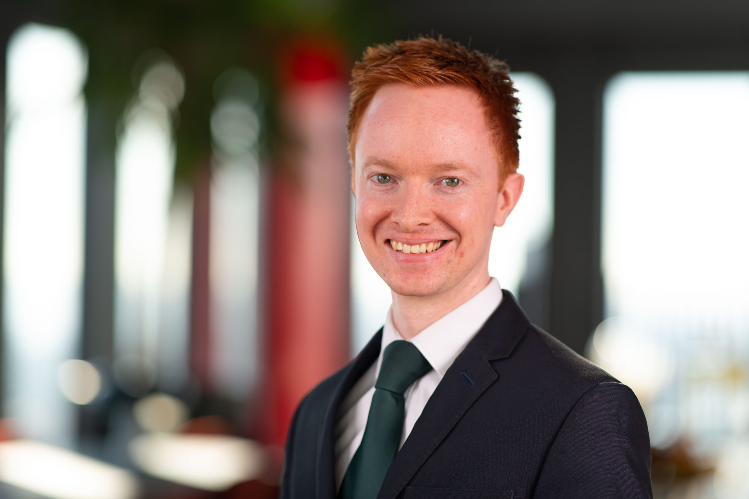 Head shot of Aidan Lloyd wearing a suit and tie | Hugh James