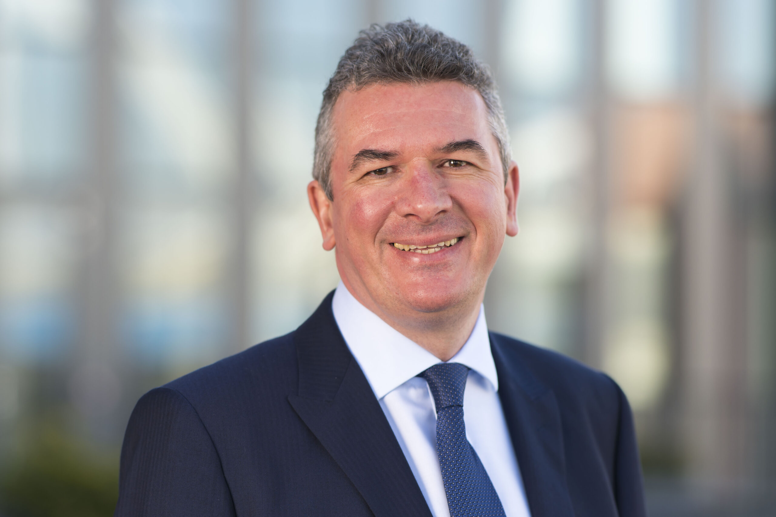 Head shot of Ciaran McCabe with suit and blue tie | Hugh James