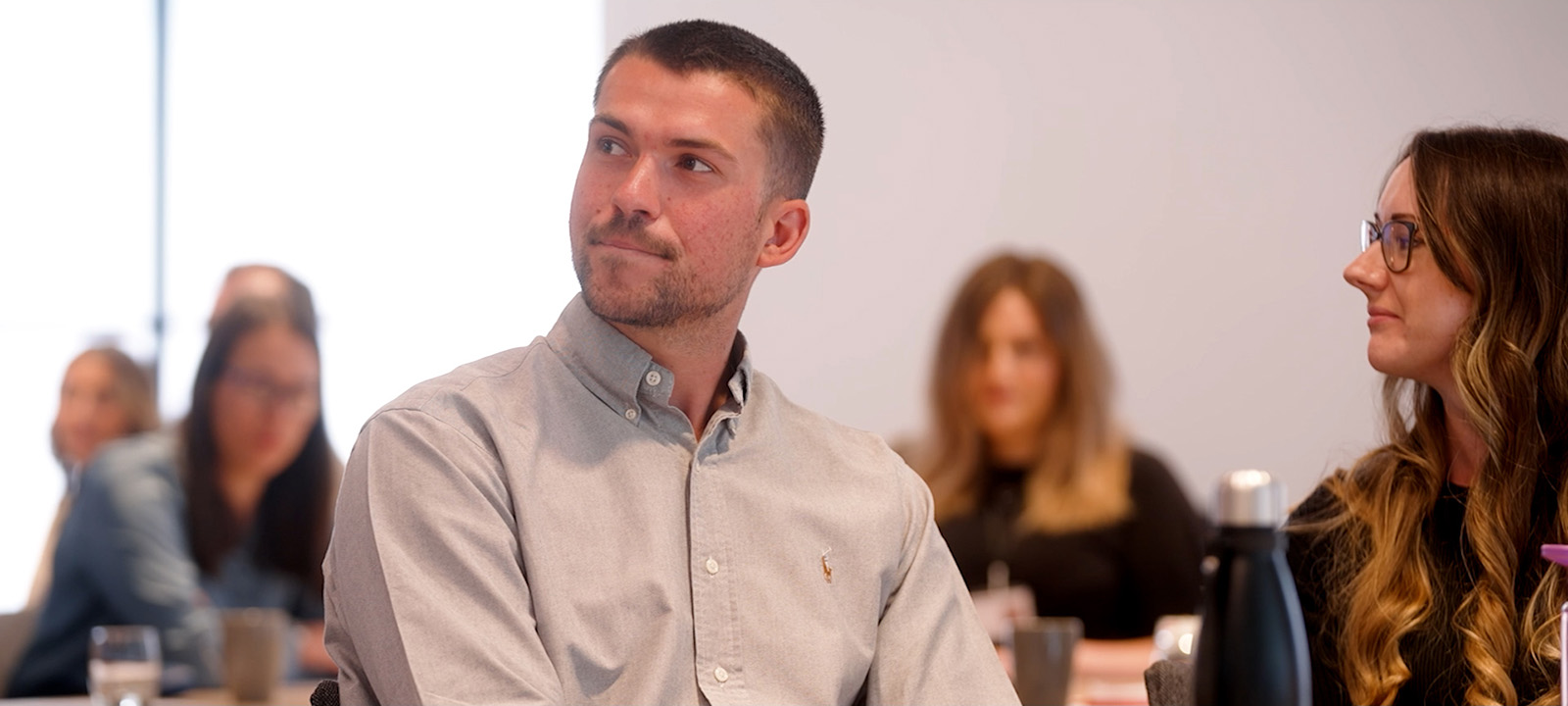 a graduate trainee listens to a Hugh James training presentation