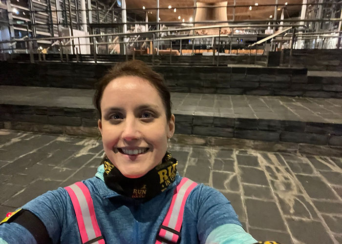 Tamlyn Palmer, Serious Injury senior associate, outside the Welsh Government building in Cardiff Bay participating in Run in the Dark to support those who suffer from paralysis