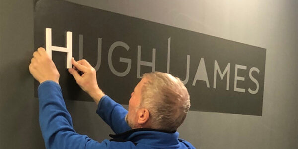 The Hugh James branding being put up in our recently acquired Manchester office, formerly Potter Rees Doalan