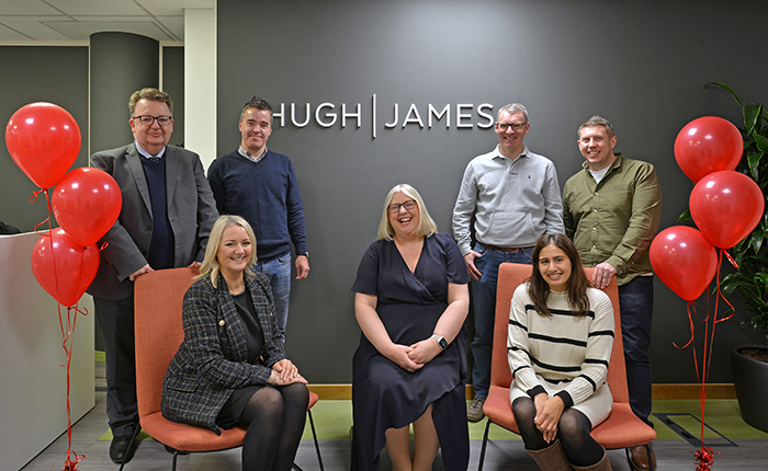 Members of our Manchester office pose with the new Hugh James branding