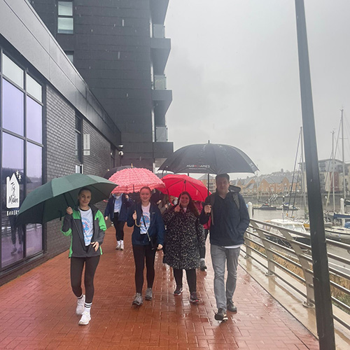 The Cardiff Asbestos team walking in the rain around Cardiff Bay during the Fitness for Feb walk for Mesothelioma UK