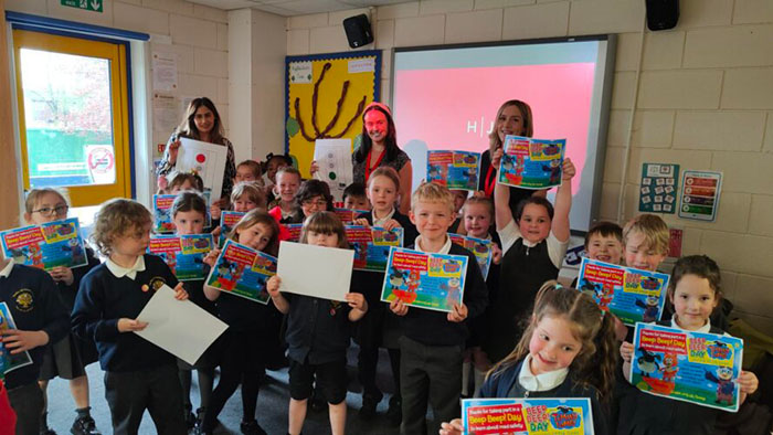 Children from the primary school show of their Brake Beep Beep! day road safety certificates
