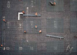 An aerial photo of workers laying foundation on a construction site.