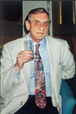 a photograph of an elderly David Ward holding a drink