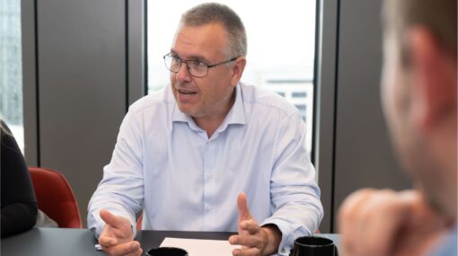 Rupert Poole chatting at a table