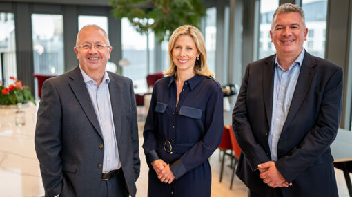 Newly acquired Serious Injury Partner, Phil Edwards, stands for a photo next to joint heads of Hugh James' serious injury team, Cari Sowden-Taylor and Ciaran McCabe in the Vista lounge of Hugh James' Cardiff office