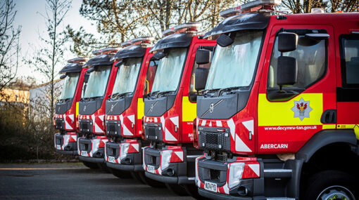 A photo of five fire engines parked side by side