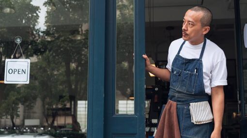 Coffee shop owner with Open sign