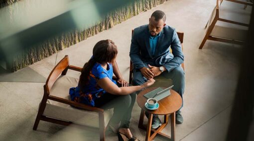 Wide shot business meeting consultation by black african financial adviser.