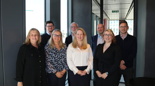 Participants from Hugh James' family law roundtable stand shoulder to shoulder in a corporate office. From left to right: Victoria Cannon, Scott Harris, Rhiannon Ford, Stuart Evans, Tracey Singlehurst-Ward, Tim English, Abigail Jones, Daniel Gornall