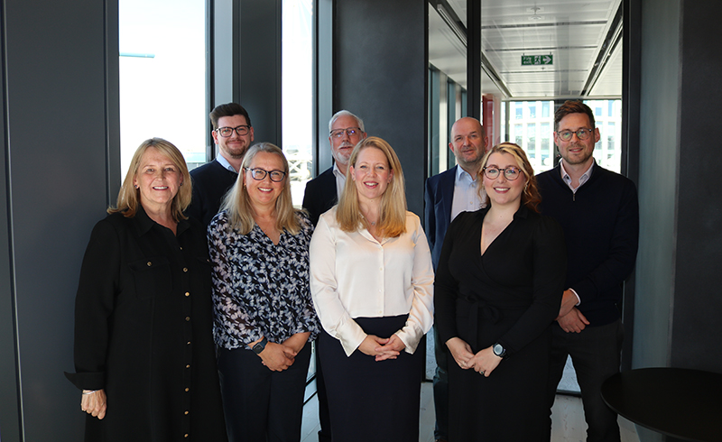 Participants from Hugh James' family law roundtable stand shoulder to shoulder in a corporate office. From left to right: Victoria Cannon, Scott Harris, Rhiannon Ford, Stuart Evans, Tracey Singlehurst-Ward, Tim English, Abigail Jones, Daniel Gornall
