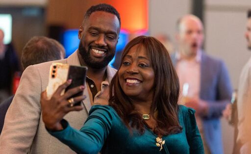 Two people smiling taking a selfie at the Hugh James Rugby Lunch 2026
